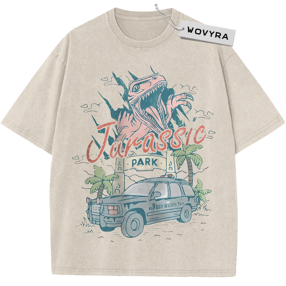 Vintage T-shirt featuring a dinosaur above a park vehicle with pastel pink and teal lettering