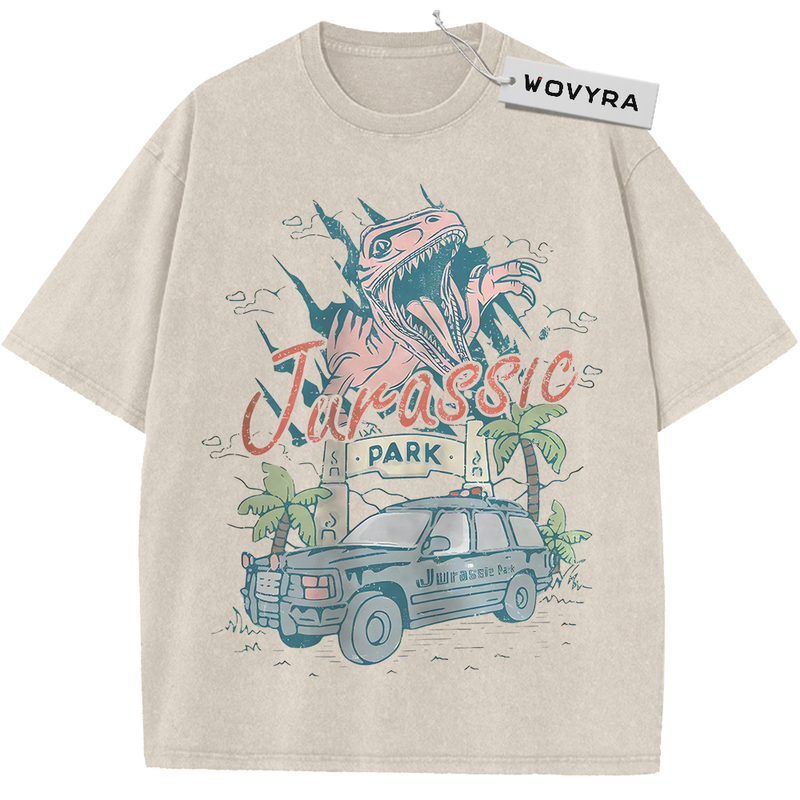 Vintage T-shirt featuring a dinosaur above a park vehicle with pastel pink and teal lettering